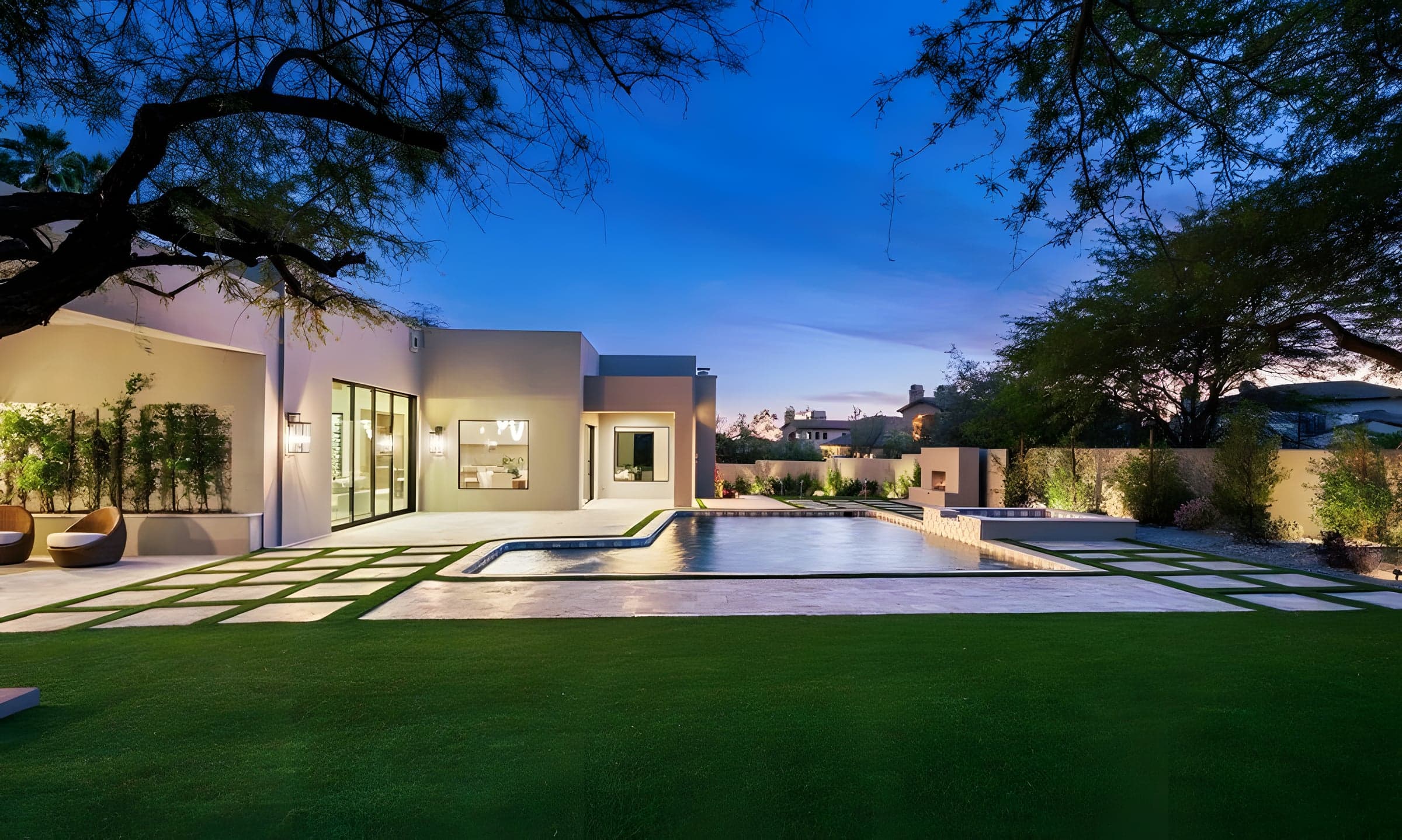 Paradise Valley pool deck and outdoor lounge at twilight with landscape lighting